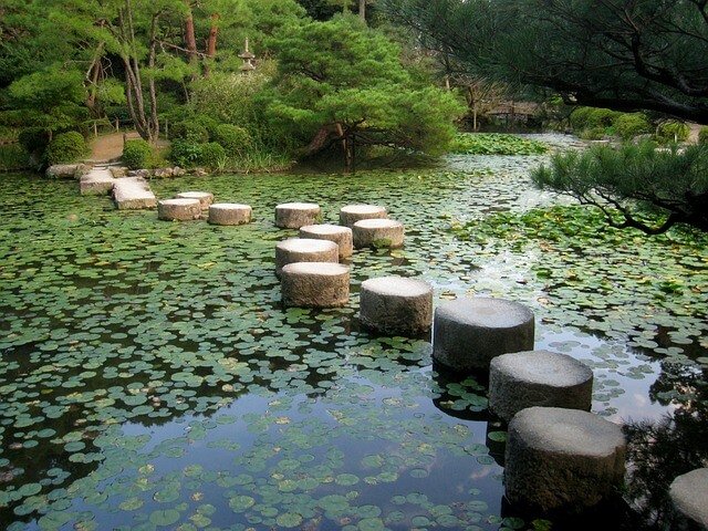 Stepping stones across calm water symbolising progress and balance between fear and phobia